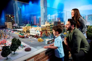 family with child looking at lego buildings